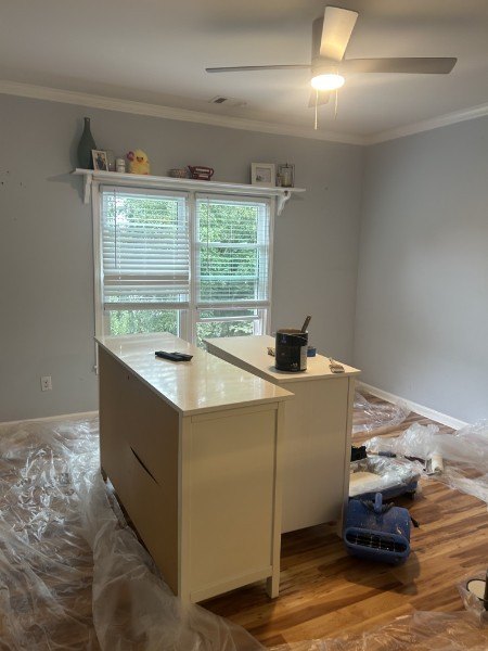 Repainted gray bedroom with a white shelf over the window and white trim