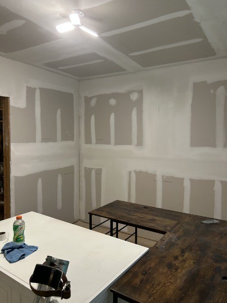 New drywall with taped and mudded seams, ready for sanding and paint